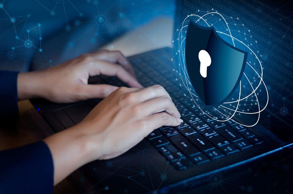 a businessman typing in his laptop and learning about cybersecurity risk management